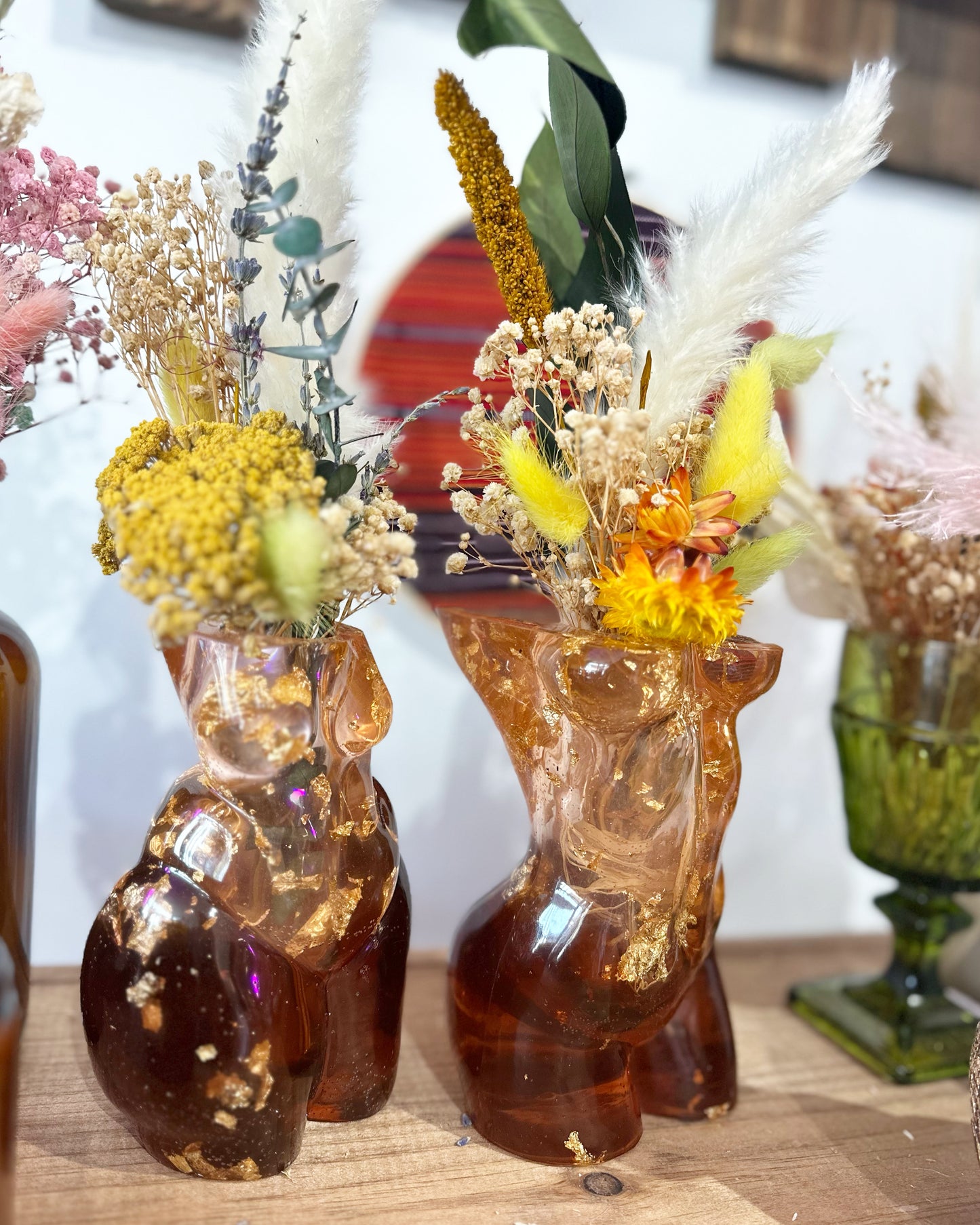 Resin vases with dried flower arrangements