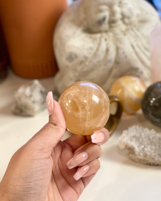 Honey calcite sphere with flash